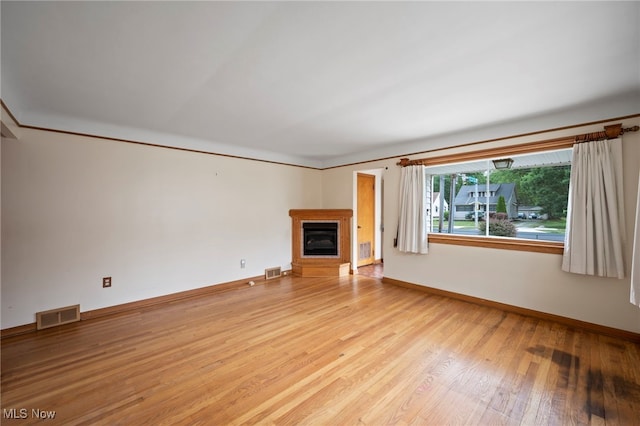 3016 Clague Rd, North Olmsted, OH 44070 - unfurnished living room featuring light wood finished floors and a glass covered fireplace