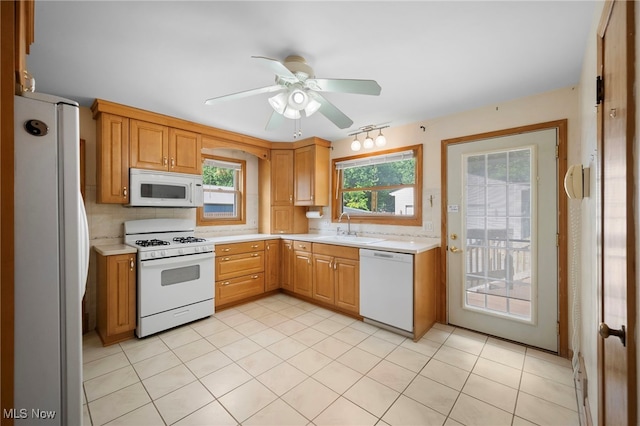 3016 Clague Rd, North Olmsted, OH 44070 - kitchen featuring white appliances, light countertops, a ceiling fan, and decorative backsplash