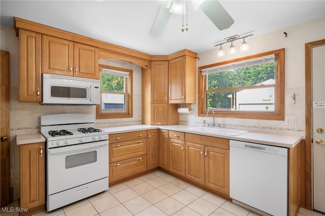 3016 Clague Rd, North Olmsted, OH 44070 - kitchen with white appliances, backsplash, and light countertops