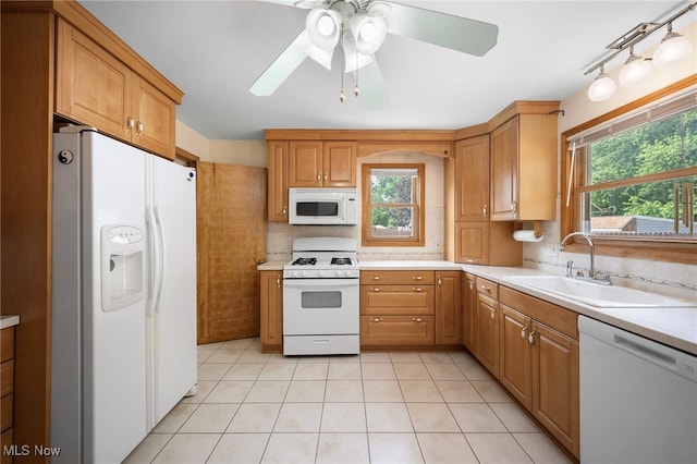 3016 Clague Rd, North Olmsted, OH 44070 - kitchen with white appliances, light countertops, tasteful backsplash, ceiling fan, and light tile patterned flooring