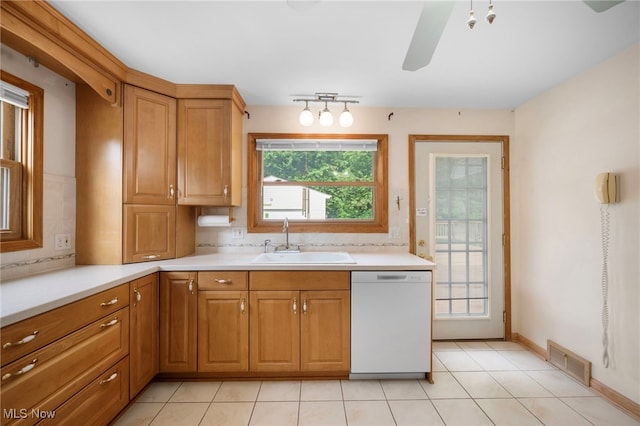 3016 Clague Rd, North Olmsted, OH 44070 - kitchen featuring dishwasher, light countertops, brown cabinets, and ceiling fan