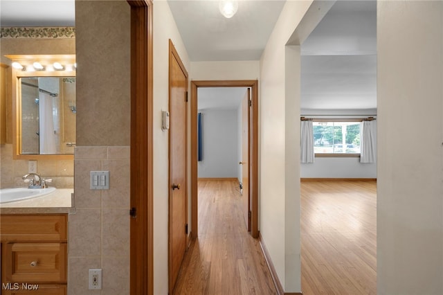 3016 Clague Rd, North Olmsted, OH 44070 - hallway featuring light wood-style floors and a sink