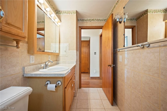 3016 Clague Rd, North Olmsted, OH 44070 - bathroom featuring tile walls, tile patterned flooring, and vanity