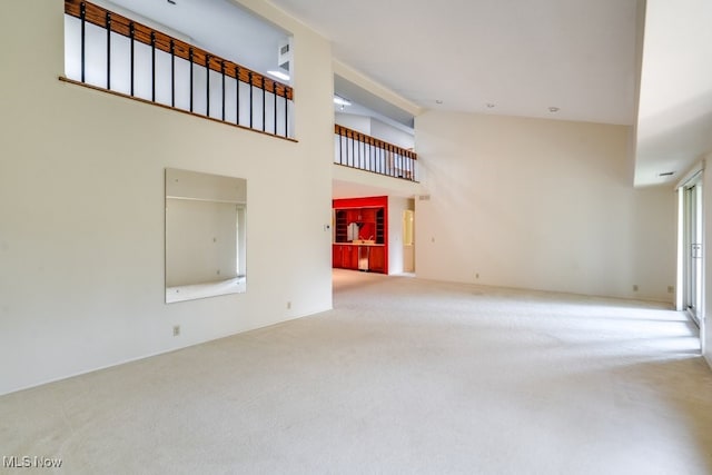 1012 Bunker Dr Unit 307, Akron, OH 44333 - unfurnished living room featuring carpet flooring and high vaulted ceiling