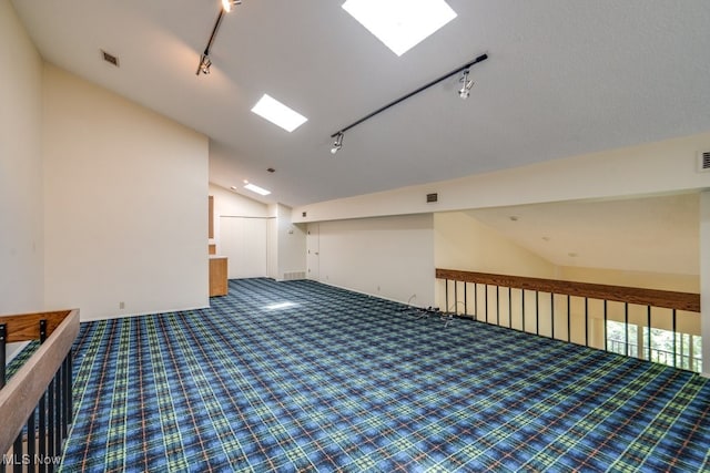 1012 Bunker Dr Unit 307, Akron, OH 44333 - carpeted empty room with rail lighting and lofted ceiling