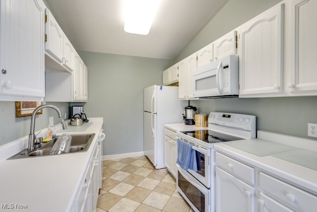 1012 Bunker Dr Unit 307, Akron, OH 44333 - kitchen featuring white appliances, white cabinetry, light countertops, and vaulted ceiling