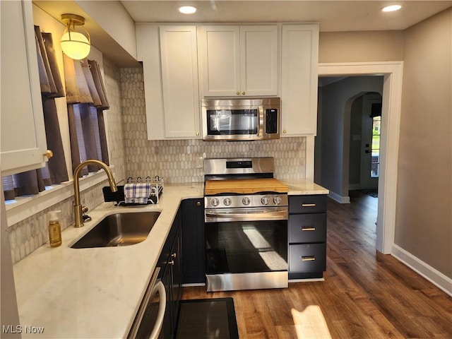 343 Genesee Ave NE, Warren, OH 44483 - kitchen with stainless steel appliances, white cabinets, light countertops, backsplash, and recessed lighting