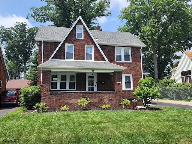 343 Genesee Ave NE, Warren, OH 44483 - view of front of house featuring a chimney, brick siding, a shingled roof, and covered porch