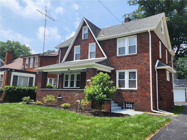 343 Genesee Ave NE, Warren, OH 44483 - view of front of house featuring a chimney, brick siding, and a front lawn