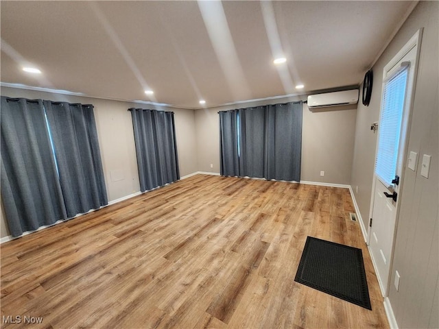 343 Genesee Ave NE, Warren, OH 44483 - empty room featuring a wall mounted AC, wood finished floors, and recessed lighting