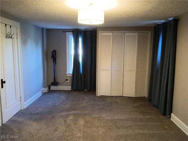 343 Genesee Ave NE, Warren, OH 44483 - unfurnished bedroom featuring dark colored carpet and a textured ceiling