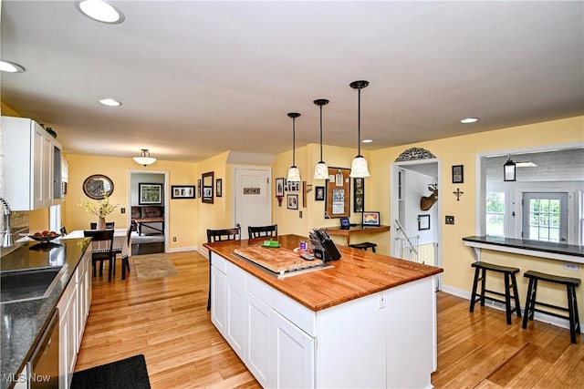 4219 3rd St NW, Canton, OH 44708 - kitchen featuring wood counters, white cabinets, dishwasher, light wood-type flooring, and recessed lighting
