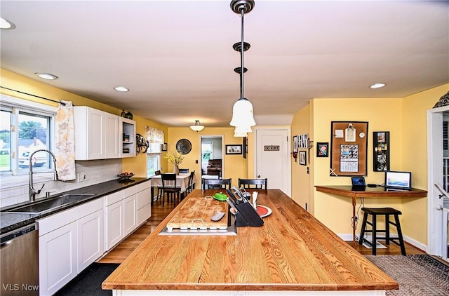 4219 3rd St NW, Canton, OH 44708 - kitchen with dishwasher, white cabinetry, dark wood-style flooring, tasteful backsplash, and hanging light fixtures