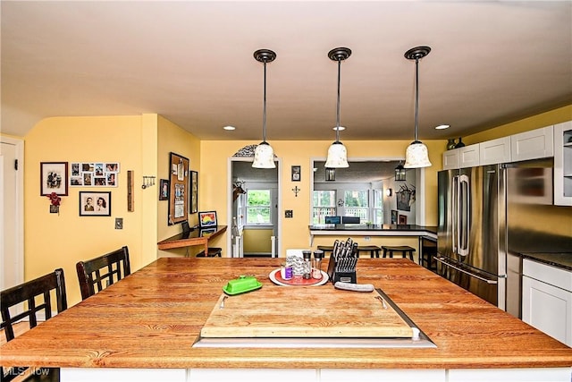4219 3rd St NW, Canton, OH 44708 - kitchen featuring freestanding refrigerator, a center island, pendant lighting, white cabinets, and recessed lighting