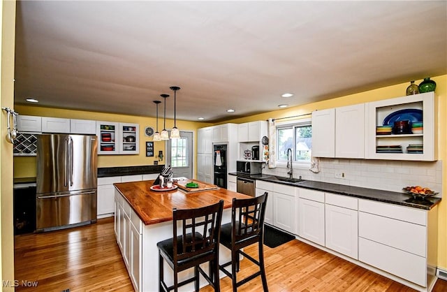 4219 3rd St NW, Canton, OH 44708 - kitchen with appliances with stainless steel finishes, butcher block countertops, healthy amount of natural light, light wood-type flooring, and recessed lighting
