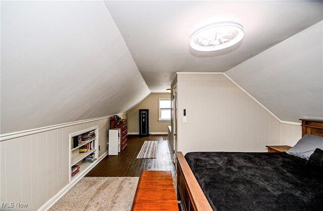 4219 3rd St NW, Canton, OH 44708 - bedroom featuring dark wood finished floors, vaulted ceiling, and wood walls