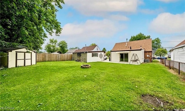 4611 W 158th St, Cleveland, OH 44135 - rear view of property with a shed, a fenced backyard, and an outdoor fire pit