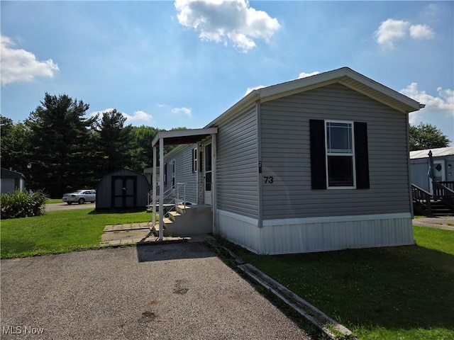 10039 State Route 700, Mantua, OH 44255 - view of side of home with a storage shed and a yard