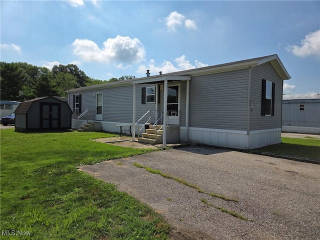 10039 State Route 700, Mantua, OH 44255 - back of property featuring a storage shed, a yard, and entry steps