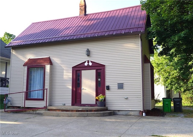208 2nd St SW, Carrollton, OH 44615 - view of front of home featuring a metal roof and a chimney