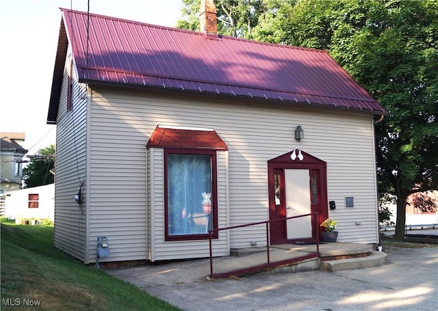 208 2nd St SW, Carrollton, OH 44615 - view of front of property featuring a chimney and a metal roof
