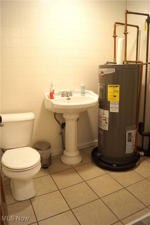 208 2nd St SW, Carrollton, OH 44615 - bathroom featuring water heater and tile patterned flooring