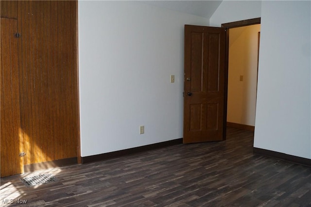 208 2nd St SW, Carrollton, OH 44615 - unfurnished room with dark wood-style flooring and vaulted ceiling
