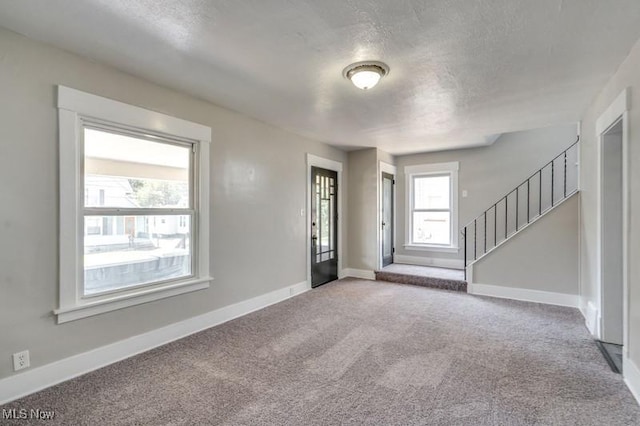 2819 4th St NW, Canton, OH 44708 - carpeted foyer featuring a textured ceiling and stairway