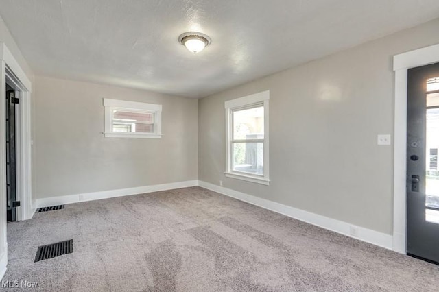 2819 4th St NW, Canton, OH 44708 - spare room featuring carpet flooring and baseboards