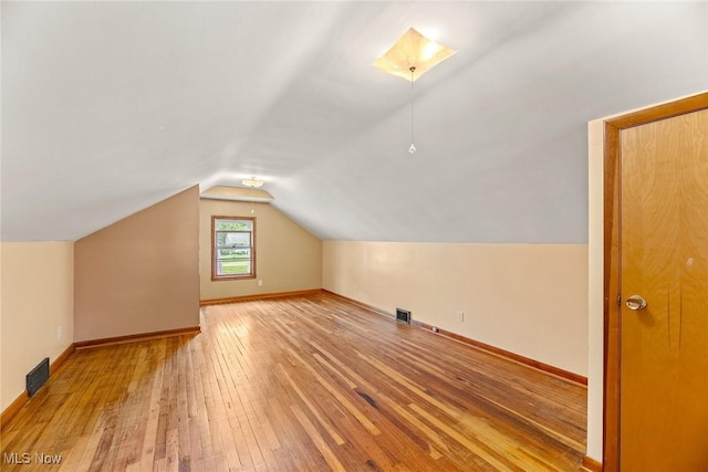 2330 Parkway Blvd, Alliance, OH 44601 - additional living space featuring hardwood / wood-style flooring and vaulted ceiling