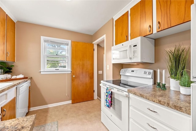 2330 Parkway Blvd, Alliance, OH 44601 - kitchen featuring white appliances and brown cabinetry