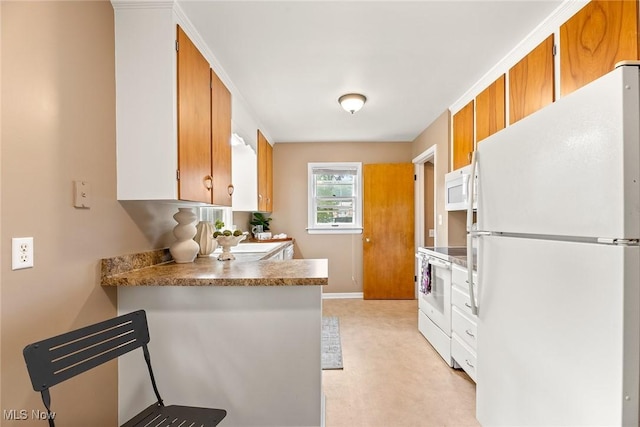 2330 Parkway Blvd, Alliance, OH 44601 - kitchen with white appliances, brown cabinets, a peninsula, and light carpet