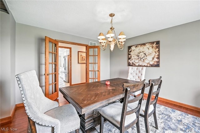 6388 Brianna Way NW, Warren, OH 44481 - dining space featuring french doors, a chandelier, and wood finished floors