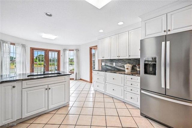6388 Brianna Way NW, Warren, OH 44481 - kitchen with stainless steel fridge, tasteful backsplash, white cabinets, healthy amount of natural light, and recessed lighting