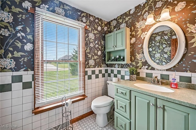 6388 Brianna Way NW, Warren, OH 44481 - half bath featuring vanity, wallpapered walls, tile patterned floors, and tile walls