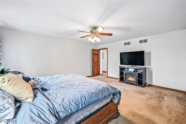 6388 Brianna Way NW, Warren, OH 44481 - bedroom featuring light colored carpet, a glass covered fireplace, and a ceiling fan