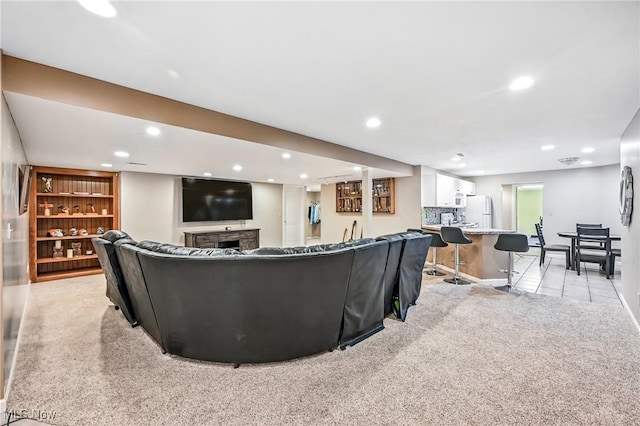 6388 Brianna Way NW, Warren, OH 44481 - living room with light colored carpet, recessed lighting, bar, and a fireplace