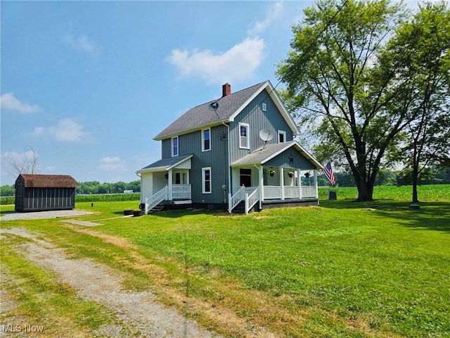 3986 Newton Falls Bailey Rd, Newton Falls, OH 44444 - rear view of property with driveway, a shed, covered porch, a lawn, and a chimney