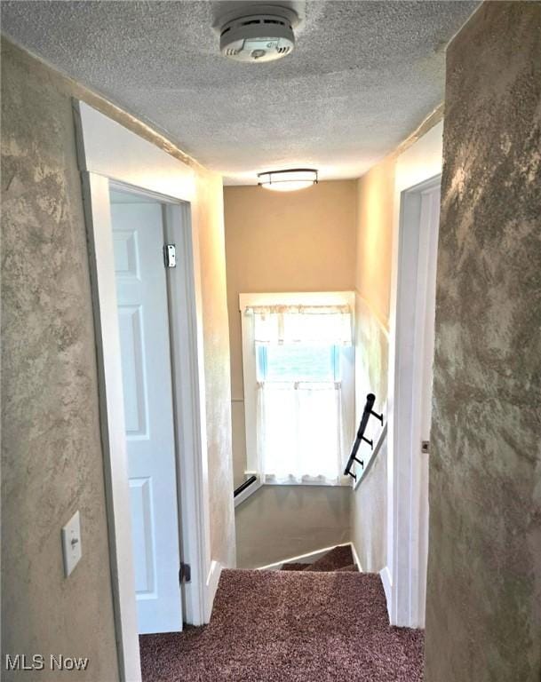 3986 Newton Falls Bailey Rd, Newton Falls, OH 44444 - hallway featuring carpet floors, a textured ceiling, and a baseboard radiator