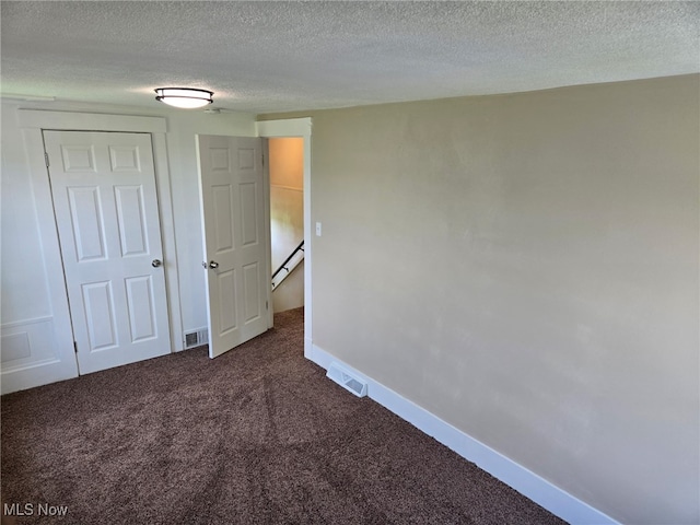 3986 Newton Falls Bailey Rd, Newton Falls, OH 44444 - unfurnished bedroom featuring dark colored carpet and a textured ceiling