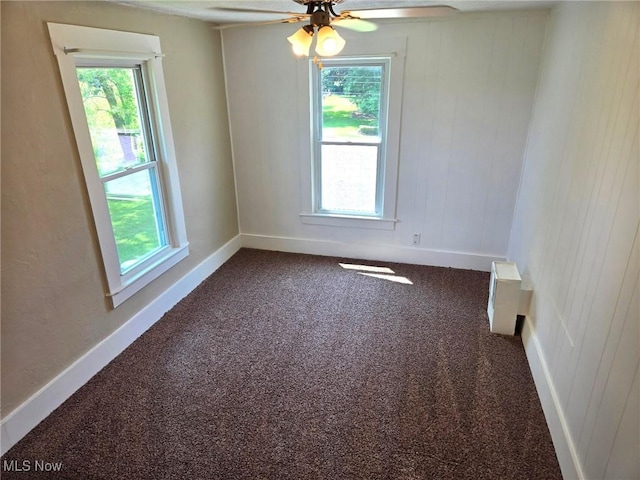 3986 Newton Falls Bailey Rd, Newton Falls, OH 44444 - unfurnished room featuring a ceiling fan, plenty of natural light, and dark colored carpet