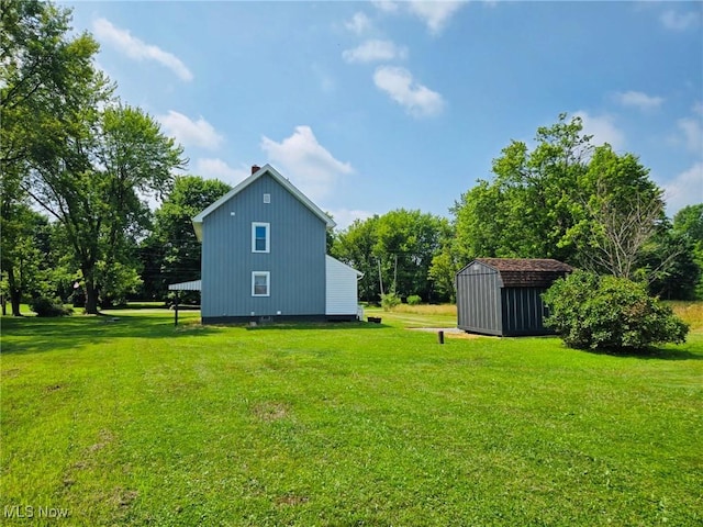 3986 Newton Falls Bailey Rd, Newton Falls, OH 44444 - view of grassy yard with a storage unit and view of wooded area