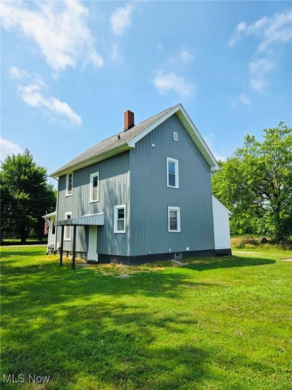3986 Newton Falls Bailey Rd, Newton Falls, OH 44444 - rear view of property featuring a yard and a chimney