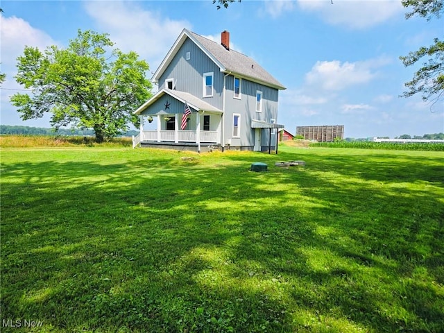 3986 Newton Falls Bailey Rd, Newton Falls, OH 44444 - back of property featuring a lawn, a chimney, and board and batten siding