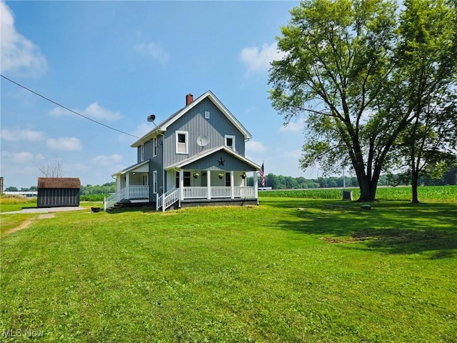 3986 Newton Falls Bailey Rd, Newton Falls, OH 44444 - back of house featuring a porch, a chimney, a storage shed, and a lawn