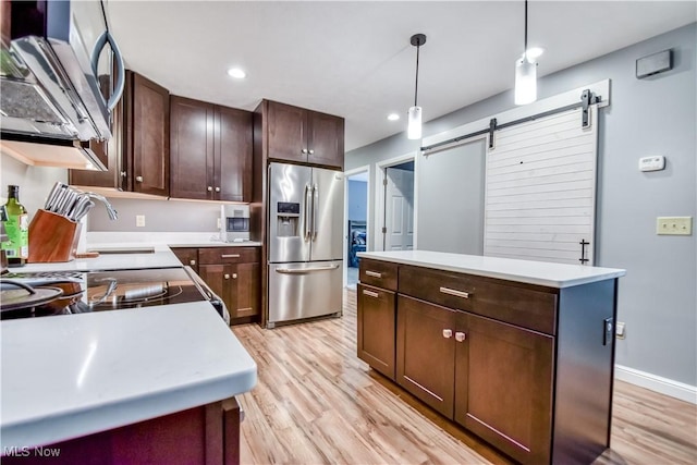 7208 S Galahad Pl, Concord Township, OH 44077 - kitchen with appliances with stainless steel finishes, light wood-style floors, a kitchen island, light countertops, and recessed lighting