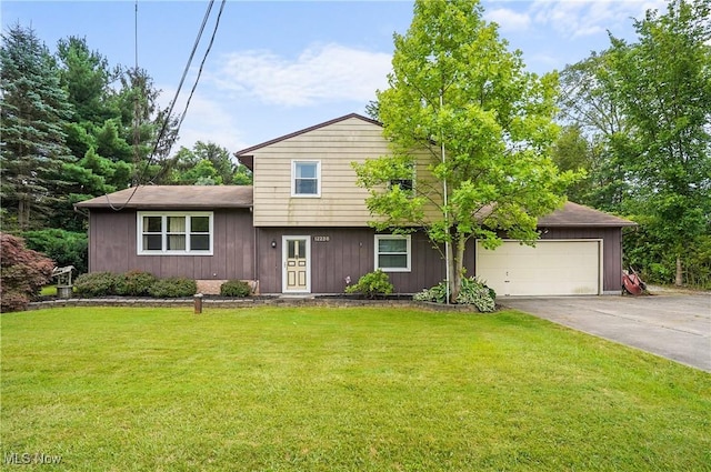 12230 Painesville Warren Rd, Concord, OH 44077 - split level home featuring concrete driveway, an attached garage, and a front yard