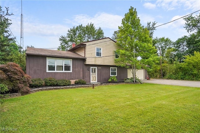 12230 Painesville Warren Rd, Concord, OH 44077 - tri-level home featuring a chimney, a front lawn, and driveway