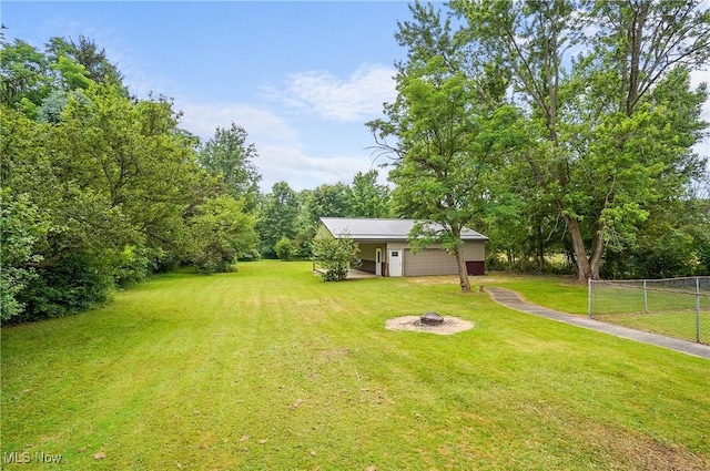 12230 Painesville Warren Rd, Concord, OH 44077 - view of yard with an outdoor fire pit