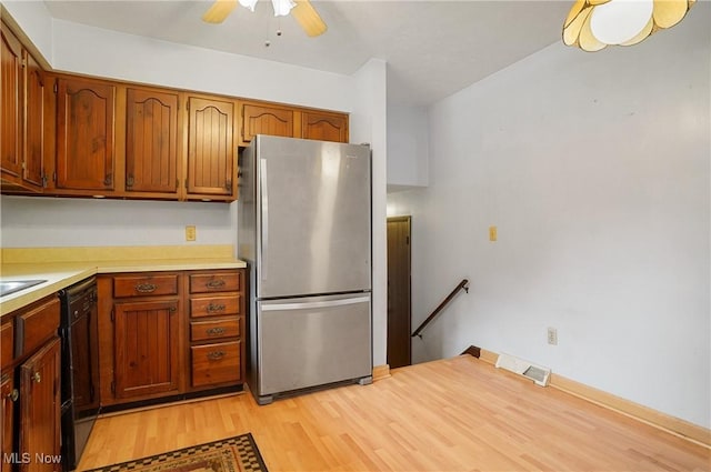 12230 Painesville Warren Rd, Concord, OH 44077 - kitchen with freestanding refrigerator, light wood finished floors, dishwasher, light countertops, and ceiling fan